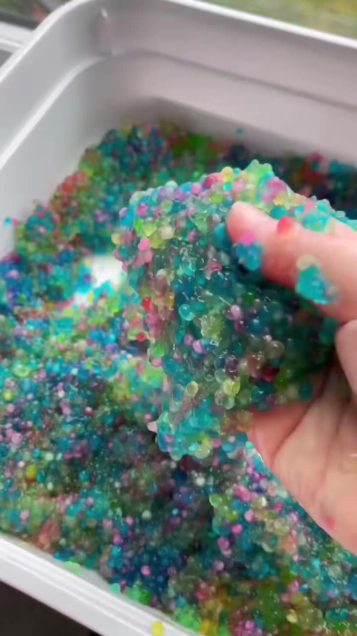 mixed colorful tapioca pearls slimy sensory play toddler hands squishing