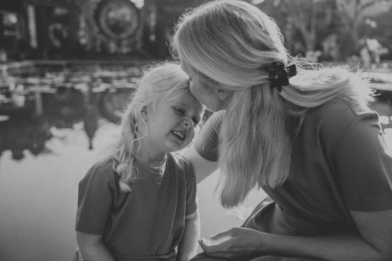 Parent kneeling to child level, speaking gently during hard moment